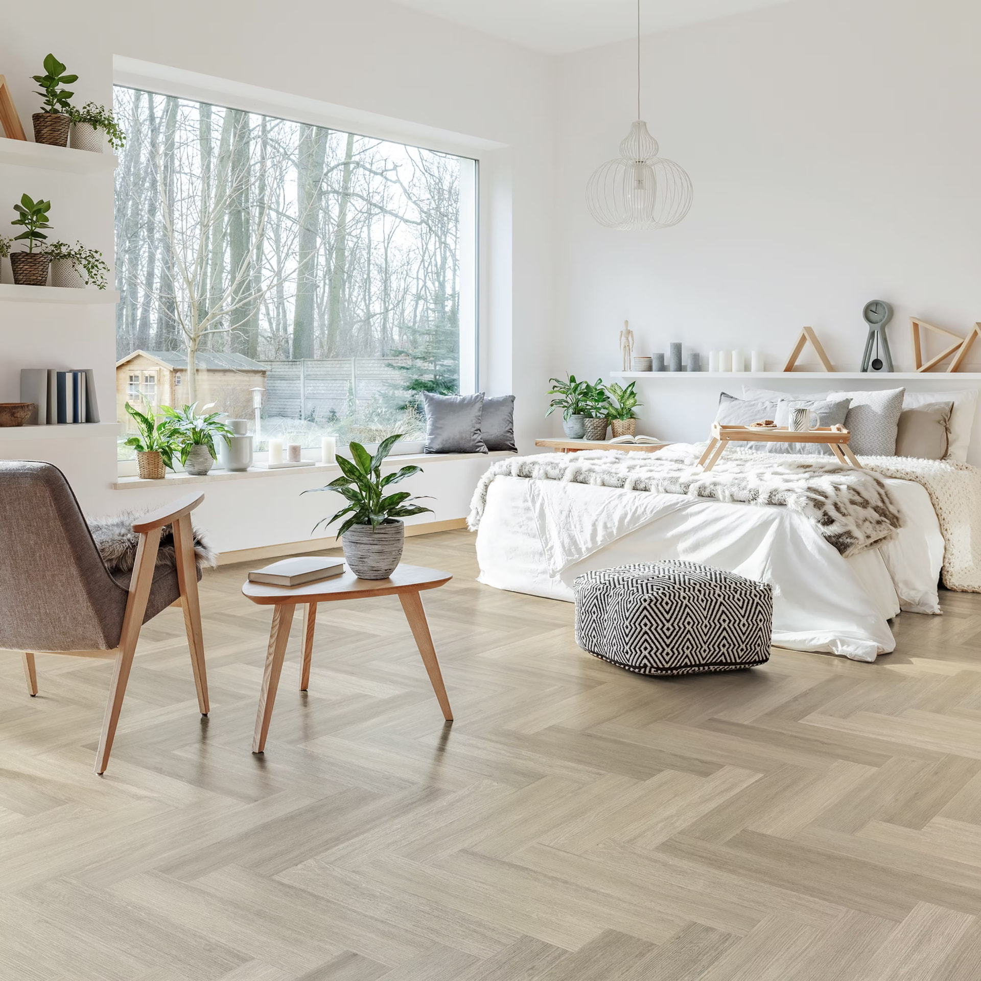 Light herringbone flooring in a bright bedroom